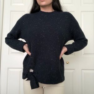 navy sweater with color speckles and a knot